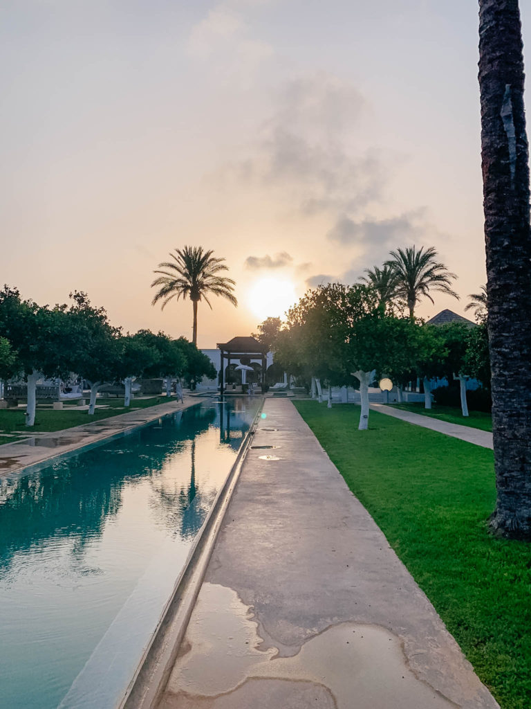 Relaxation pools and lush greenery at Atzaró Spa Ibiza during sunset
